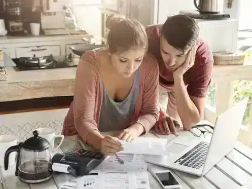 Stressed couple going over financial work