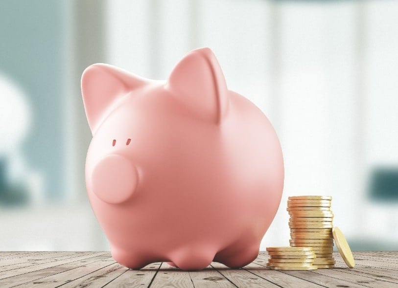 piggy bank with coins next to it