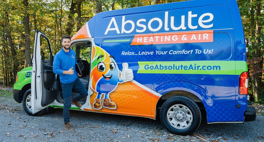 Absolute tech in front of company van.