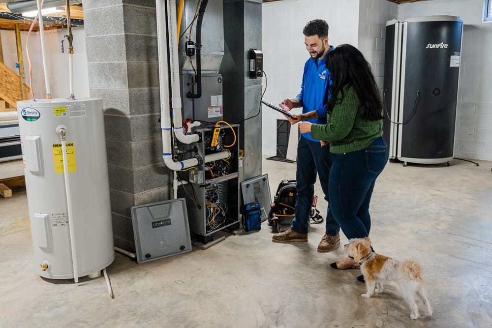 Technician installing a dehumidifier into a heater.