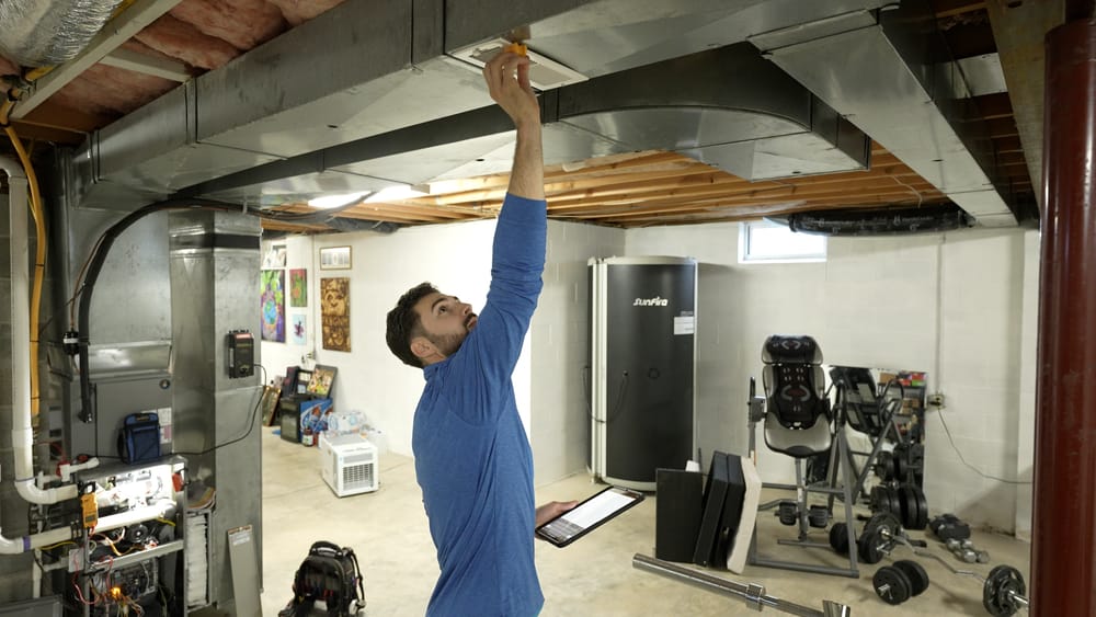 Technician inspecting ducts before an air duct cleaning service.