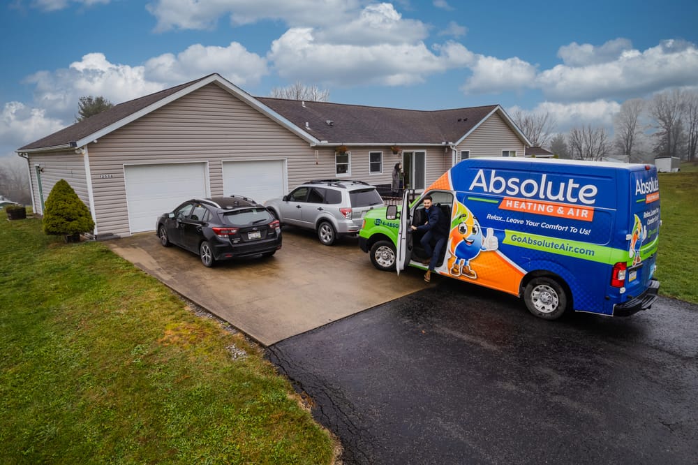 Absolute van parked in driveway.