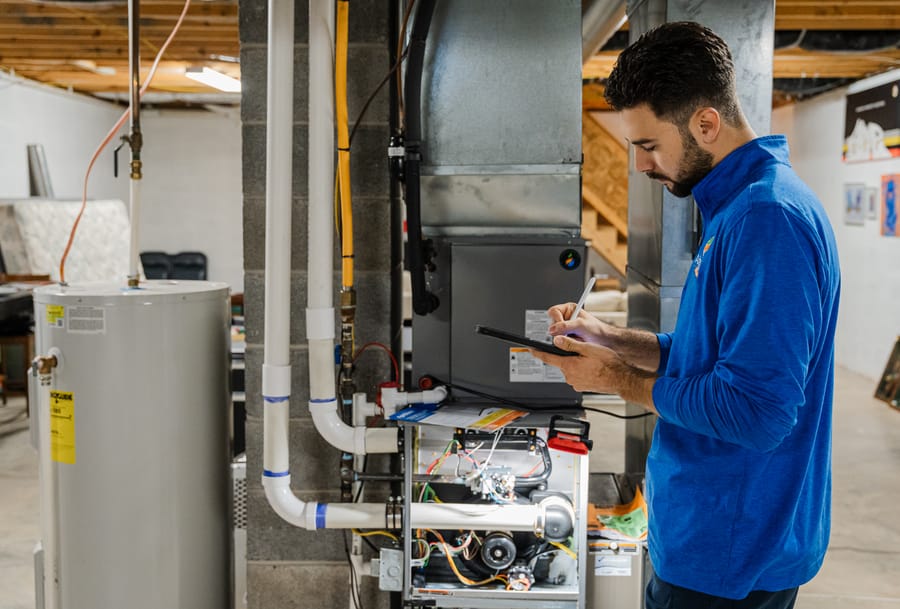 Technician servicing a water heater.
