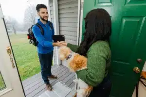 Comfort Club advisor shaking hands with customer in home.
